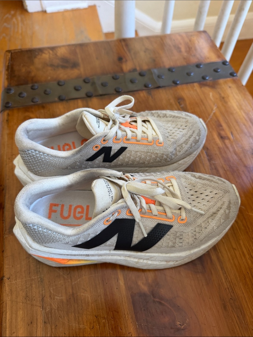 New Balance Women's Beige Athletic Shoes with Black Logo and Orange Accents